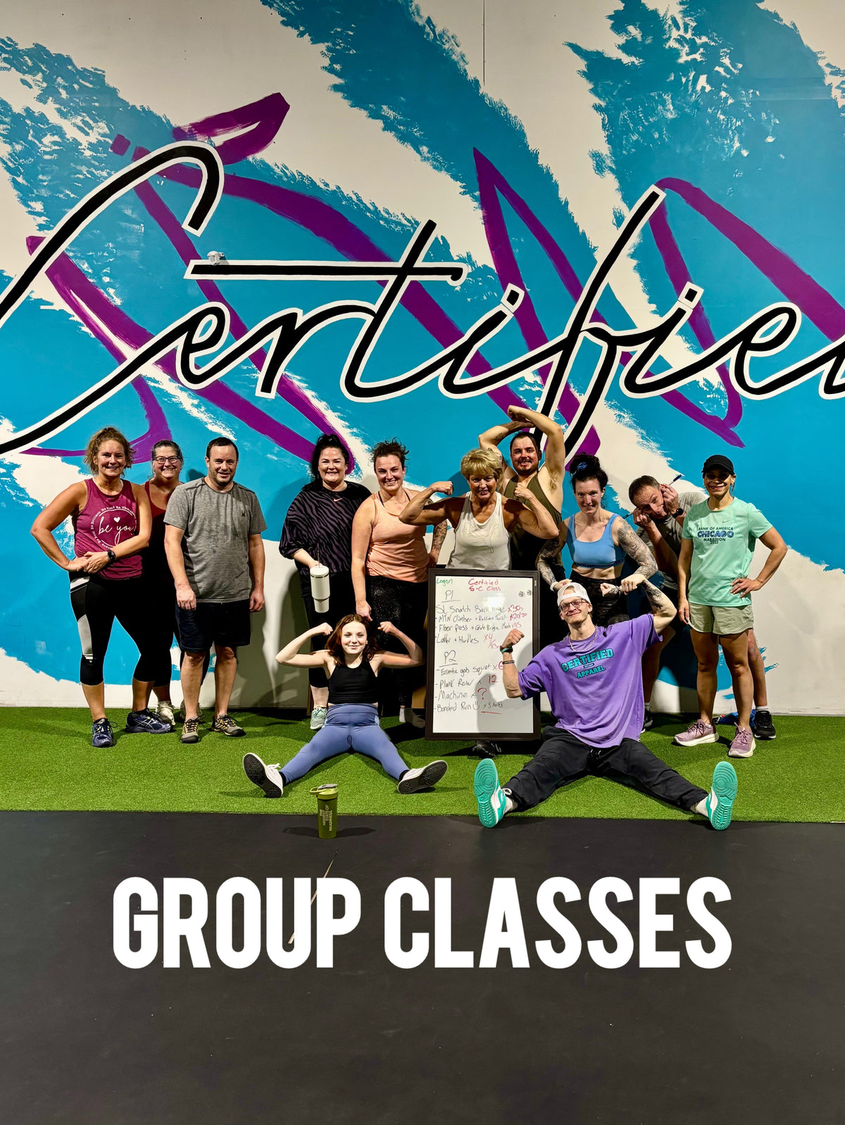 A Certified Athletics group class posing together in front of the mural after a session